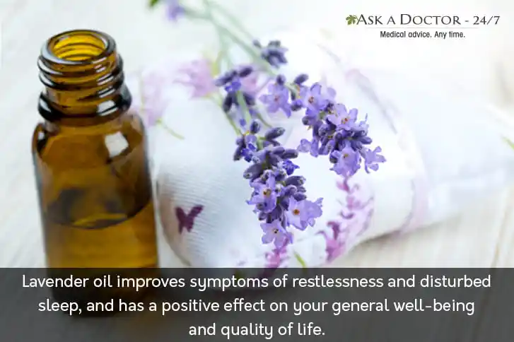  a bottle of lavendar essential oil with lavender flower kept aside=